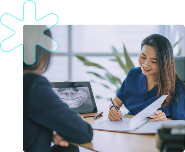 Dentist taking notes with patient